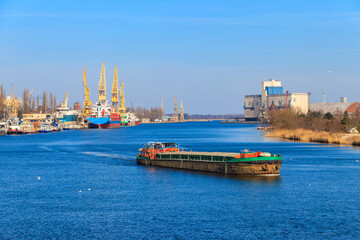 Barge sailing on the Oder river in Szczecin, Poland © olyasolod