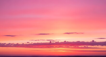 Obraz premium Vibrant sunset scene with clouds viewed from a distance in a serene landscape setting