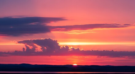 Fototapeta premium Serene landscape of plants at sunset with vibrant clouds reflecting on water
