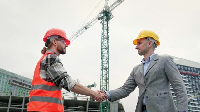 General contractor greeting subcontractor on building site