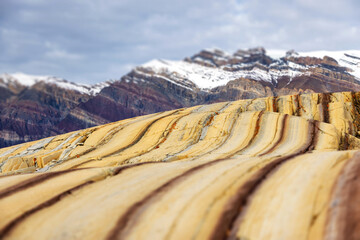 Selective focus of the wave rocks at Segelsallskapet, in Geologfjord, Northeast Greenland National Park. Renowned for colourful rock formations, with strata of red and yellow. © Rixie