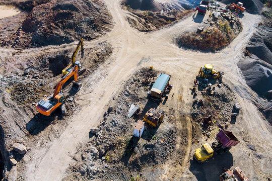 Construction site machinery working moving materials in gravel pit