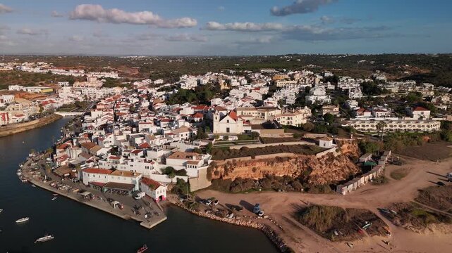 Scenic Drone Orbiting Shot of Traditional Ferragudo Town on the Arade River Algarve