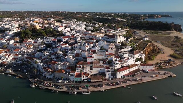Aerial Orbit of Ferragudo Traditional Fishing Village on Arade River Algarve Portugal