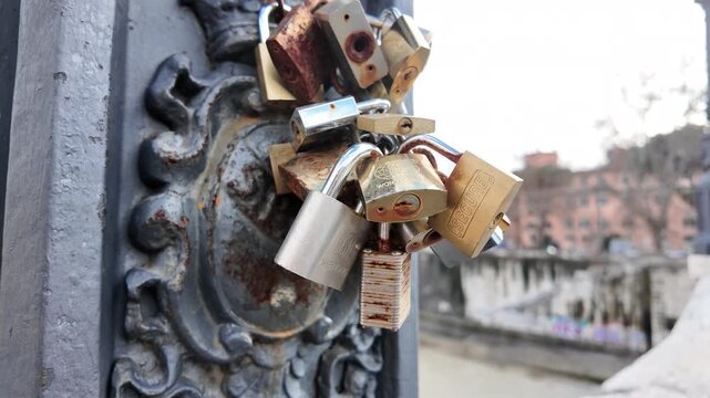 Slow Motion Close-up of Love Padlocks on a Bridge Fence at Sunset