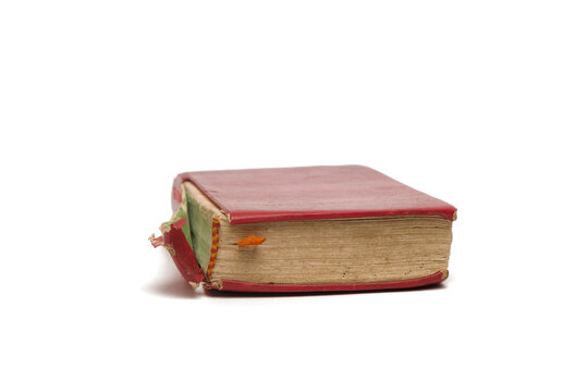 Close up vintage red book with damaged red cover isolated white background. Image of old book or bible. Copy space for text. For graphic design, 3D rendering and banners