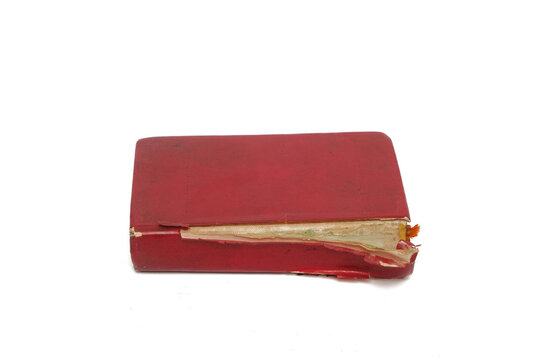 Close up vintage red book with damaged red cover isolated white background. Image of old book or bible. Copy space for text. For graphic design, 3D rendering and banners