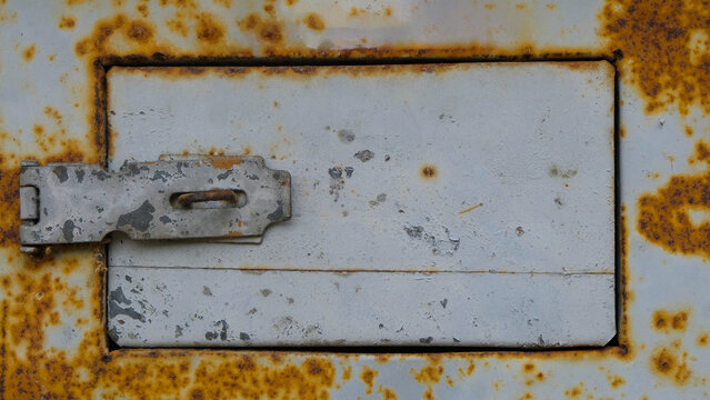 Close up of a small door on a rusty iron box. For graphic design, 3D rendering and banners