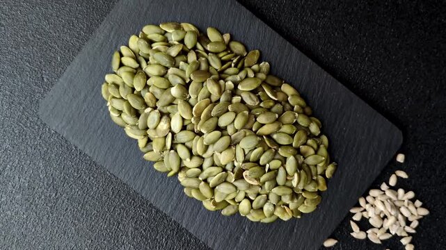 Shelled pumpkin seed kernels, salted, roasted, or raw, are a healthy ingredient. Pumpkin seeds as a food background for your design