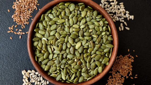 Shelled pumpkin seed kernels, salted, roasted, or raw, are a healthy ingredient. Pumpkin seeds as a food background for your design