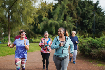 Group of multiracial senior friends running at city park - Fit elderly people having fun doing sport endurance workout together outdoor © Sabrina