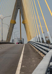 Stretching across the Chao Phraya River, the Rama VIII Bridge is an asymmetrical masterpiece of gold and steel. Its pylon anchors 84 yellow cables that radiate like celestial rays, casting a permanent