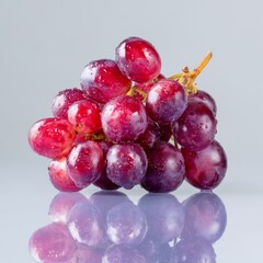 Fresh and Juicy Red Grapes with Water Droplets on a Reflective Surface for Healthy Eating Concepts