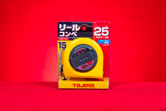ZHONGSHAN China-October 19 2025: 15m Tajima tape measure on red.