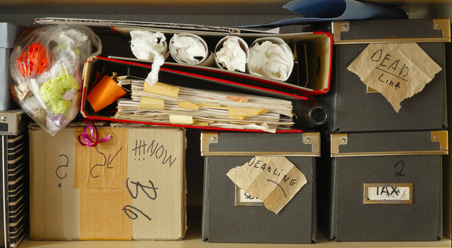 grungy messy file folders and ringbinders and paper boxes with deadline messages