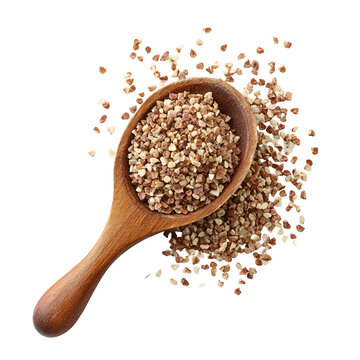 Wooden spoon filled with buckwheat groats on a white background