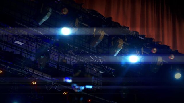 Stage lights illuminating concert truss structure with lens flare