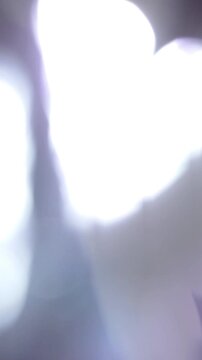 Moving Vertical Flashing Light Bokeh Transition, Bright Abstract Light Flare Across Dark Background Motion. best for transition wipe
