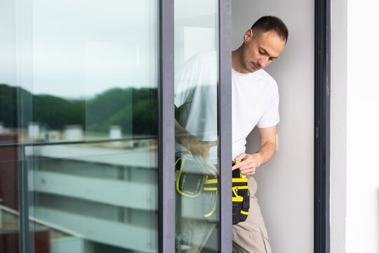 man installing aluminum frame sliding terrace doors