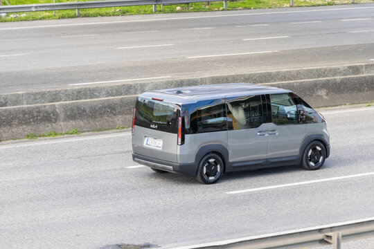 Kia pbv concept vehicle driving on asphalt highway