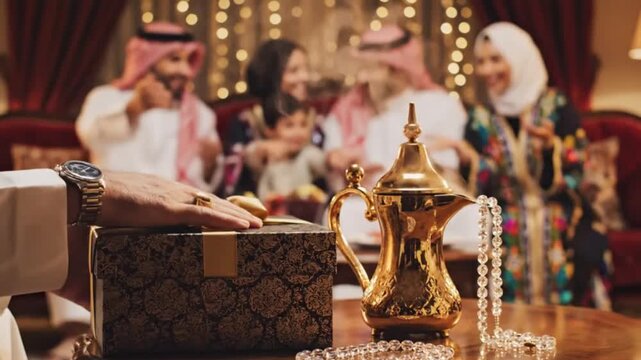 Generative AI: Close Up Hands Exchanging Luxury Black and Gold Gift Box with Blurred Saudi Family Background and Golden Dallah for Eid Celebration