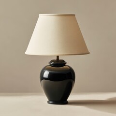 Table lamp made of black ceramic with a fabric shade on a simple background at home