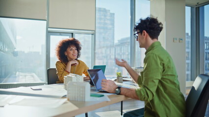 Obraz premium Real estate agents working in office space. Multiethnic colleagues discussing