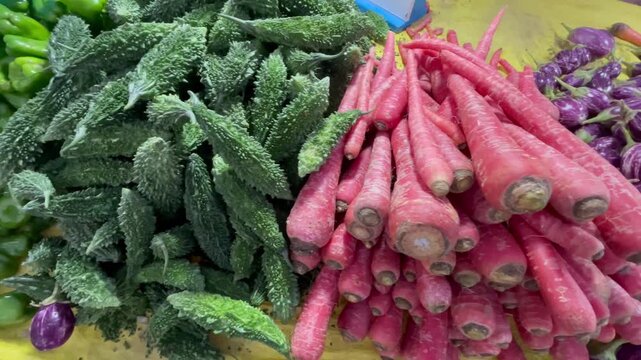 Fresh Bitter Gourd and Red Carrots capsicum and other vegetables Displayed at Local Vegetable Market