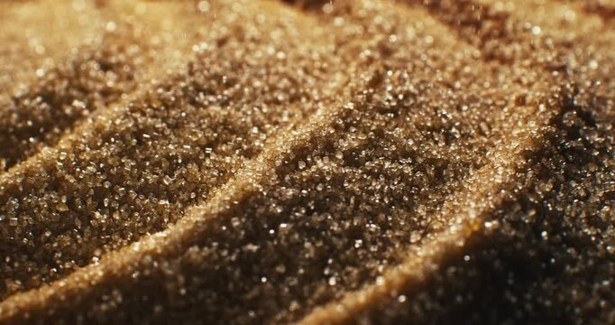 Slow Motion Of Brown Sugar Crystal Macro Close Up. Sparkling Granulated Texture Concept Of Sweet Food Background