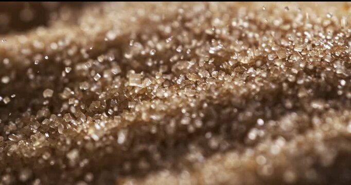 Slow Motion Macro Of Falling Brown Sugar Crystal. Sparkling Granulated Texture Concept Of Sweet Food Background
