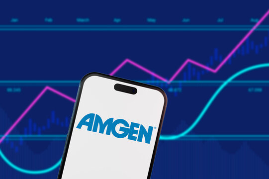 Brooklyn.New York.USA-13.02.2026: Amgen logo on a smartphone screen with biotech market charts. Concept for biopharmaceutical industry stocks and healthcare trading