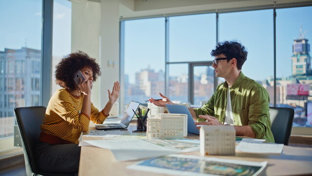 Worried team talking smartphone in construction agency office. Woman calling
