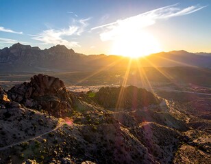 Obraz premium Sunrise illuminates distant mountain range, casting long rays