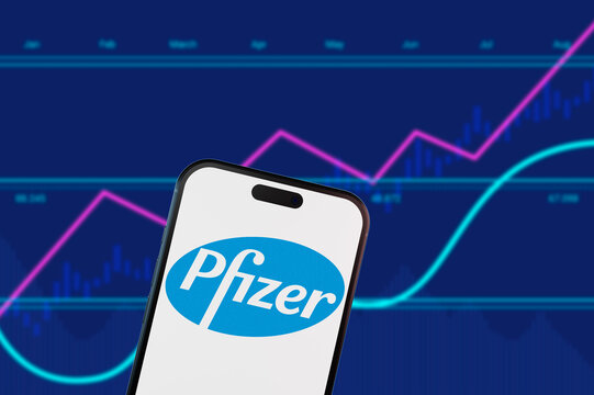 Brooklyn.New York.USA-02.13.2026:Pfizer logo on a smartphone screen over a blue financial stock market chart background