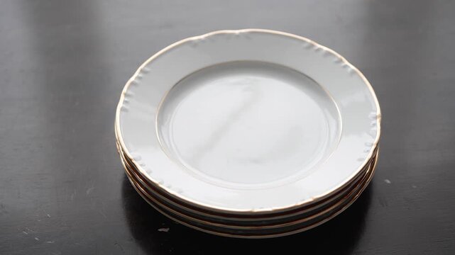 Close-up of Ceramic Plates Stacking with Resonant Clatter and Ringing Sound