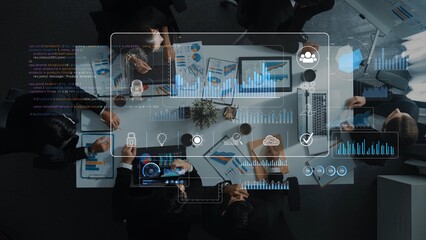 A diverse team engages in a strategic meeting, analyzing charts and data on a laptop and documents,...