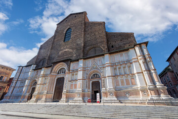 Basilica of San Petronio stands tall on Piazza Maggiore in Bologna, Emilia-Romagna, showing its rich history and architecture under a bright sky © Sergey