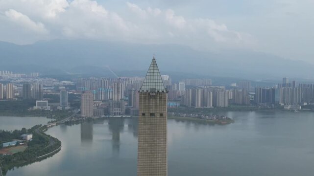 Jiujiang Tower Monument with Cityscape and Water Aerial View