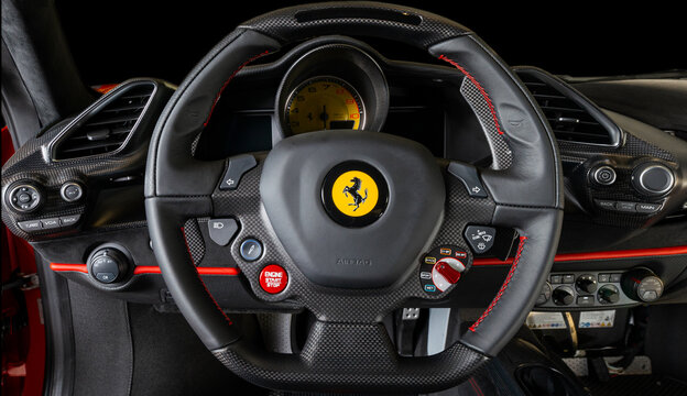Detailed close-up of the carbon fiber multi-function steering wheel and instrument cluster of a Ferrari 488 Pista.