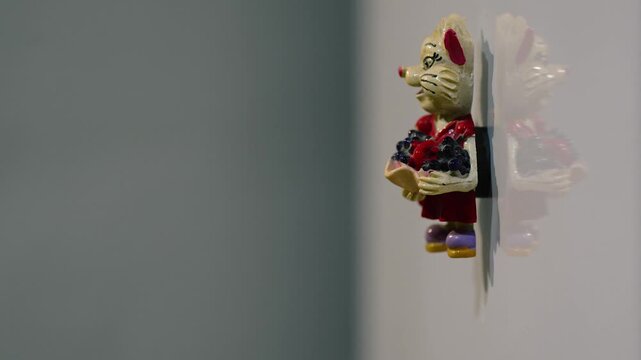 Placing ceramic souvenir magnet on refrigerator metal door with thud sound