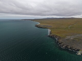 Obraz premium Aerial view showing vast Chukotka subarctic wilderness with dramatic coastal terrain and pristine nature displaying exploration potential for travel photographers and all adventurers
