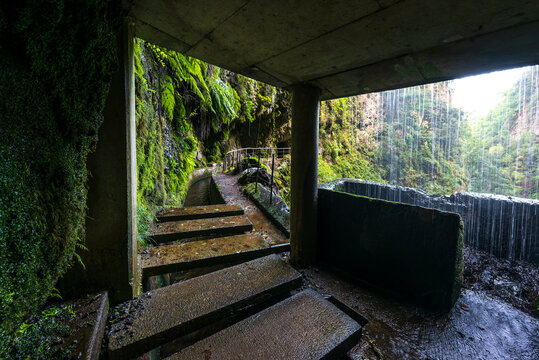 View from inside the small hut under a waterfall at the "Levada da Ribeira de Janela", one of the most picturesque levada hiking trails in the Laurissilva laurel forest on Madeira, Portugal