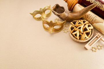 Purim holiday attributes featuring masks, hamantaschen, and gragger on light background