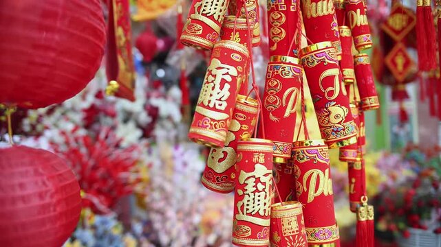 Colorful red and golden decorative elements sold on an vietnamese street market prior to the Tet holiday or Lunar new year in Vietnam, Asia. Selective focus close up video.