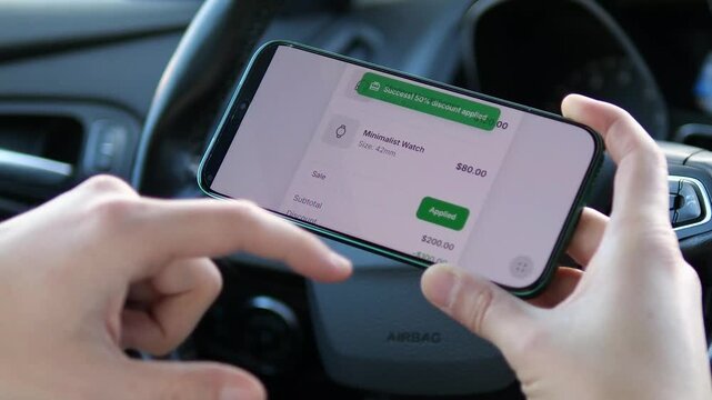 Save big on the go. User applies a 50 percent discount code in a mobile shopping app inside a car. Features a clean UI with headphones and a watch in the cart, plus a success banner. Perfect for