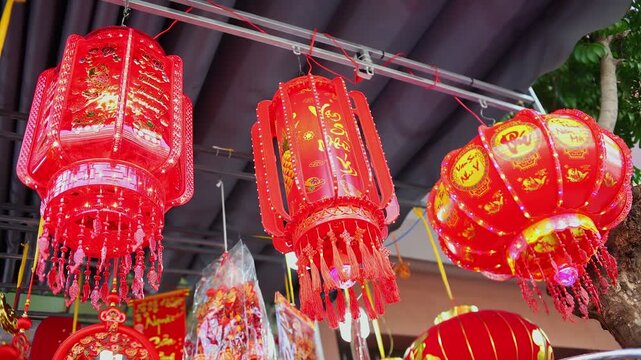 Colorful red and golden decorative elements sold on an vietnamese street market prior to the Tet holiday or Lunar new year in Vietnam, Asia. Selective focus close up video.