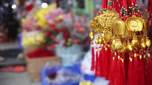 Colorful red and golden decorative elements sold on an vietnamese street market prior to the Tet holiday or Lunar new year in Vietnam, Asia. Selective focus close up video.