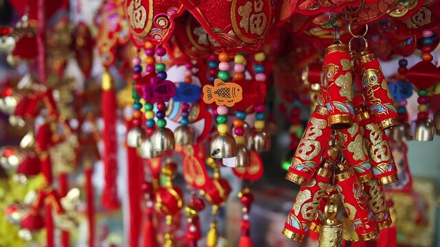Colorful red and golden decorative elements sold on an vietnamese street market prior to the Tet holiday or Lunar new year in Vietnam, Asia. Selective focus close up video.