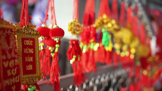Colorful red and golden decorative elements sold on an vietnamese street market prior to the Tet holiday or Lunar new year in Vietnam, Asia. Selective focus close up video.