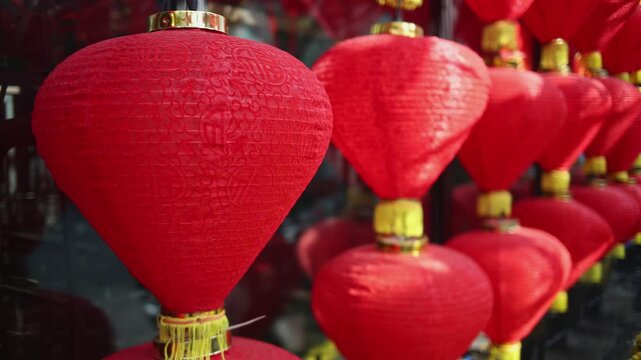 Colorful red and golden decorative elements sold on an vietnamese street market prior to the Tet holiday or Lunar new year in Vietnam, Asia. Selective focus close up video.